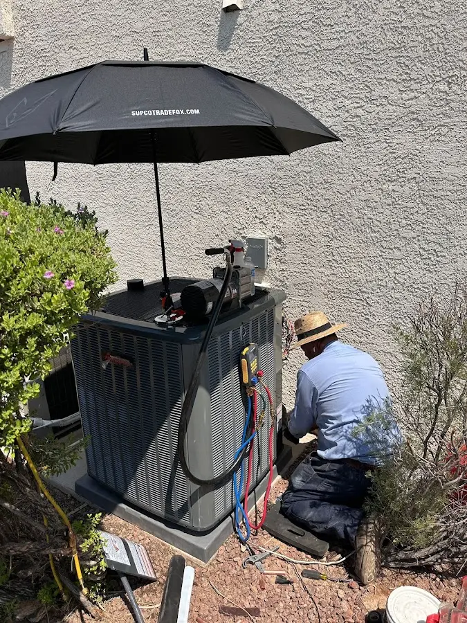 HVAC technician performing outdoor AC maintenance in South Berwick